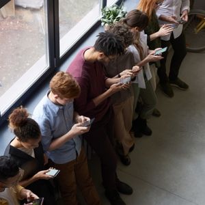 Group of people using their mobile phones